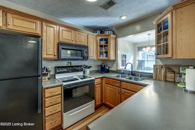 kitchen with sink, a chandelier, a textured ceiling, pendant lighting, and black appliances