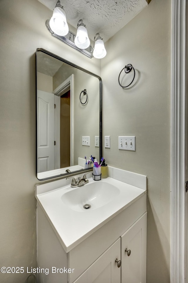 bathroom with vanity and a textured ceiling