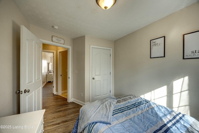 bedroom featuring wood-type flooring and a textured ceiling