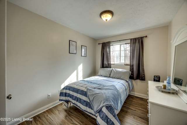 bedroom featuring dark hardwood / wood-style floors and a textured ceiling