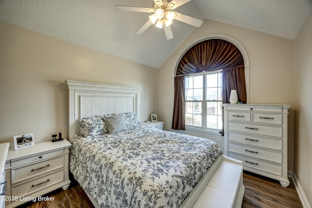 bedroom with ceiling fan, lofted ceiling, and dark hardwood / wood-style floors