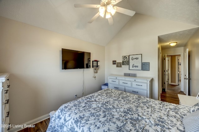 bedroom featuring dark wood-type flooring, ceiling fan, and vaulted ceiling