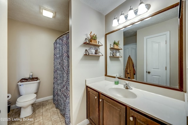 bathroom featuring vanity, toilet, tile patterned flooring, and a textured ceiling