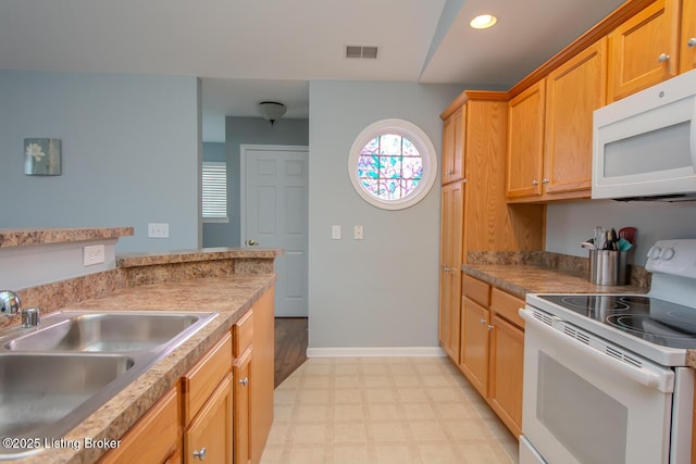 kitchen featuring sink and white appliances