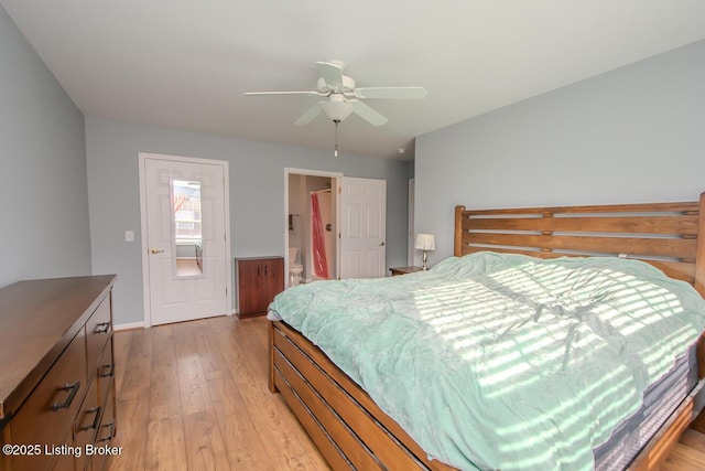 bedroom featuring ceiling fan, ensuite bath, and light hardwood / wood-style floors