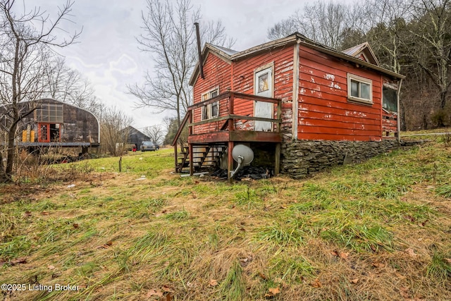 back of property featuring a yard