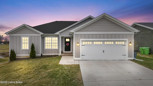 view of front of property featuring a garage and a lawn