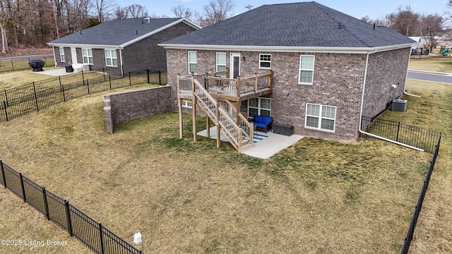 rear view of house featuring cooling unit, a patio area, a deck, and a lawn