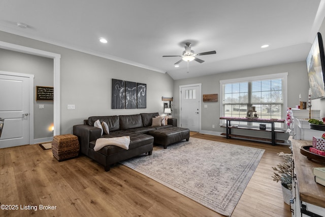 living room with light hardwood / wood-style flooring and ceiling fan