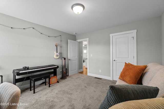 sitting room featuring light carpet