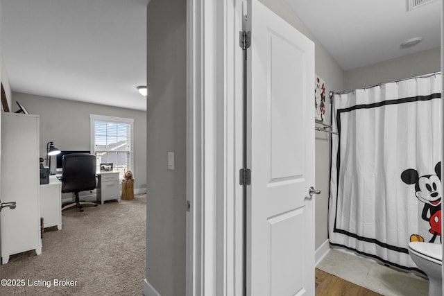 bathroom with curtained shower and toilet