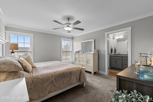 bedroom featuring sink, ensuite bath, ceiling fan, carpet, and ornamental molding