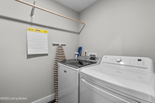 clothes washing area with washer and dryer