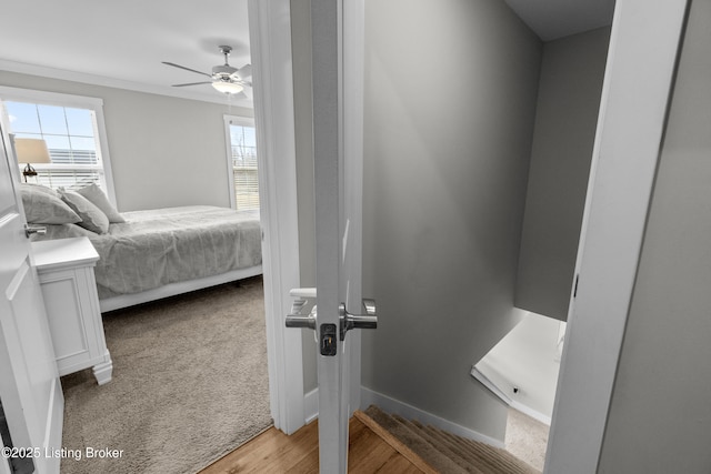 bedroom with ceiling fan, ornamental molding, and light wood-type flooring