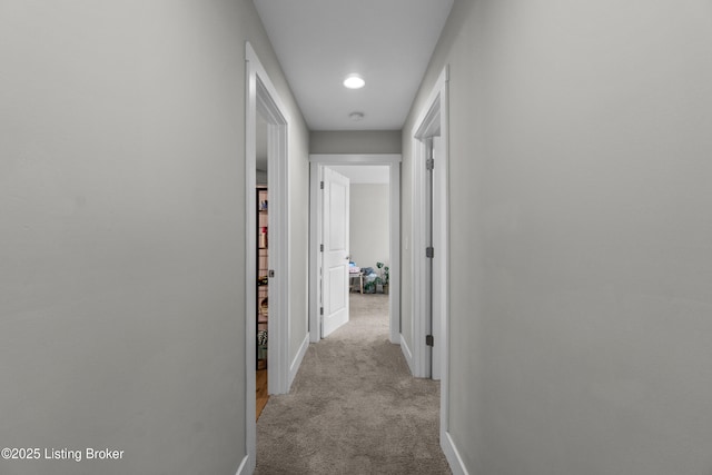 hallway featuring light carpet