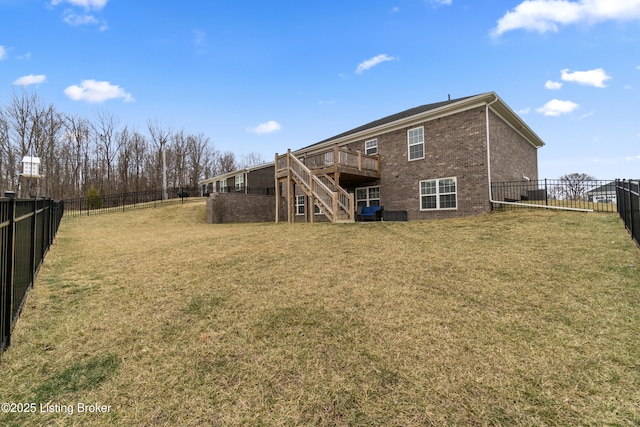 rear view of property with a wooden deck and a yard