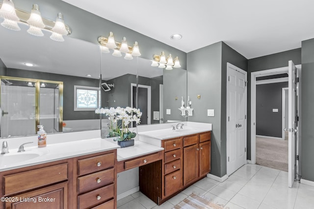 bathroom with vanity, a shower with door, and tile patterned floors