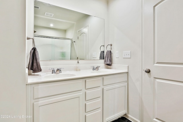 bathroom featuring vanity and a shower with shower door