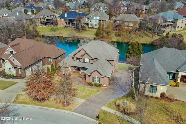 drone / aerial view with a residential view and a water view