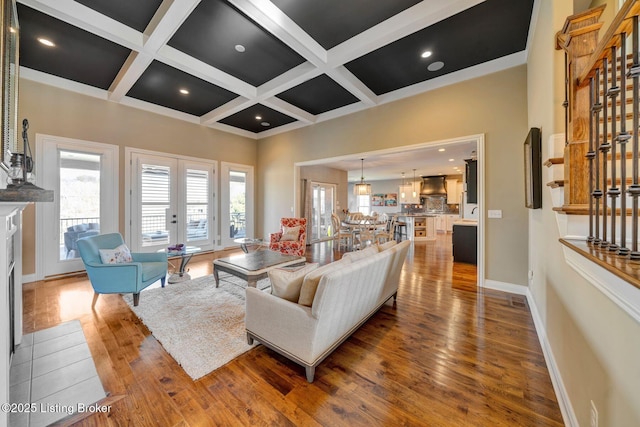 living area with coffered ceiling, french doors, baseboards, and wood-type flooring