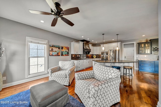 living room featuring recessed lighting, baseboards, ceiling fan, and dark wood-style flooring