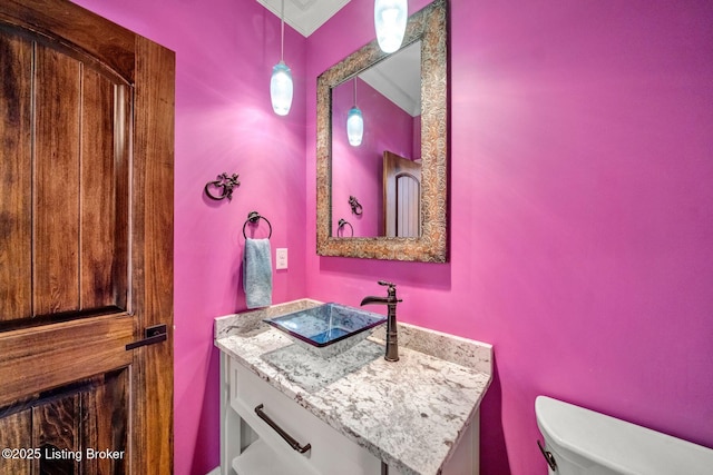 bathroom featuring toilet and vanity