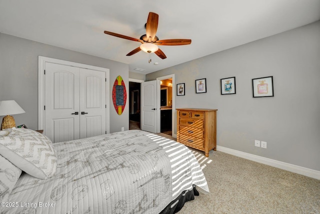 bedroom with a closet, ceiling fan, carpet, and baseboards