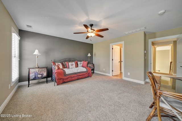 bedroom with multiple windows, visible vents, and light carpet