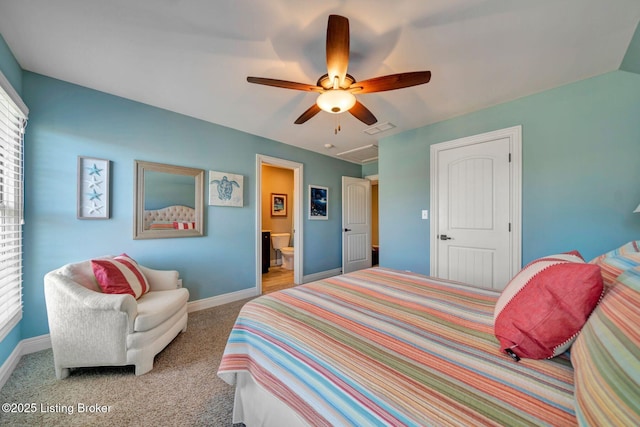 carpeted bedroom featuring ensuite bath, baseboards, visible vents, and ceiling fan