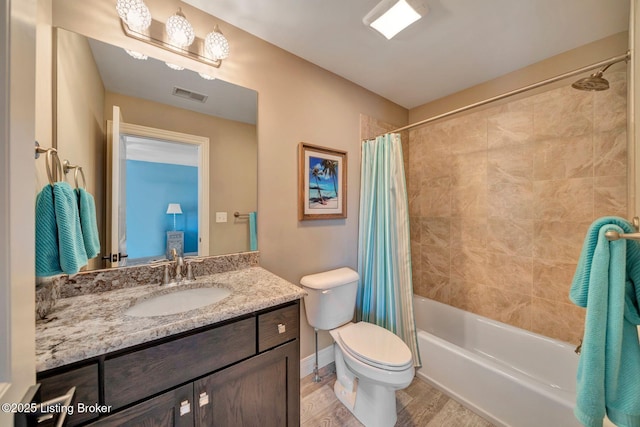 bathroom featuring visible vents, toilet, shower / bath combo with shower curtain, wood finished floors, and vanity