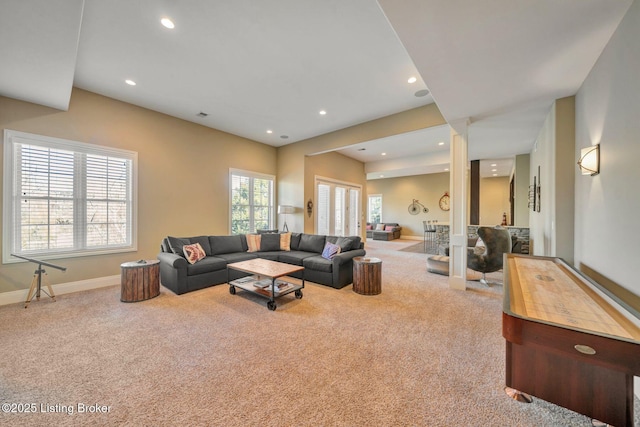 carpeted living area with recessed lighting and baseboards