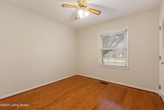 spare room featuring wood-type flooring and ceiling fan