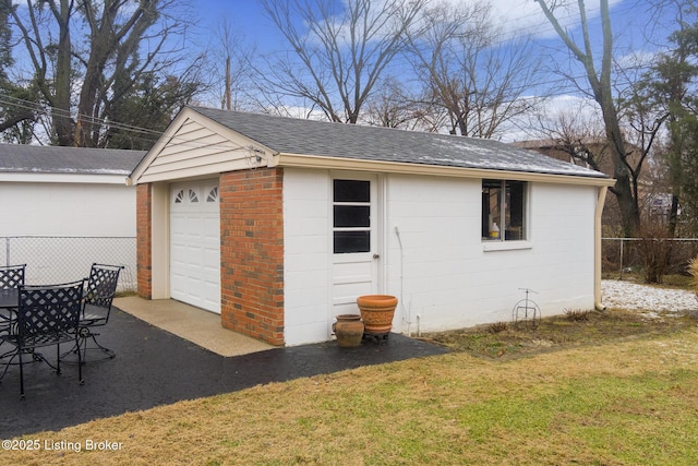 view of outdoor structure with a yard and a garage