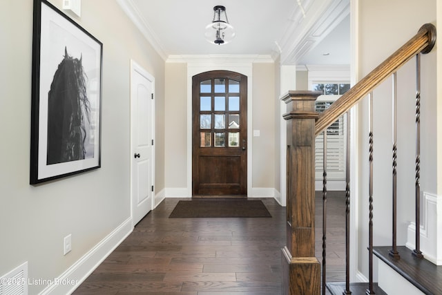 foyer featuring visible vents, baseboards, ornamental molding, stairway, and dark wood-style floors