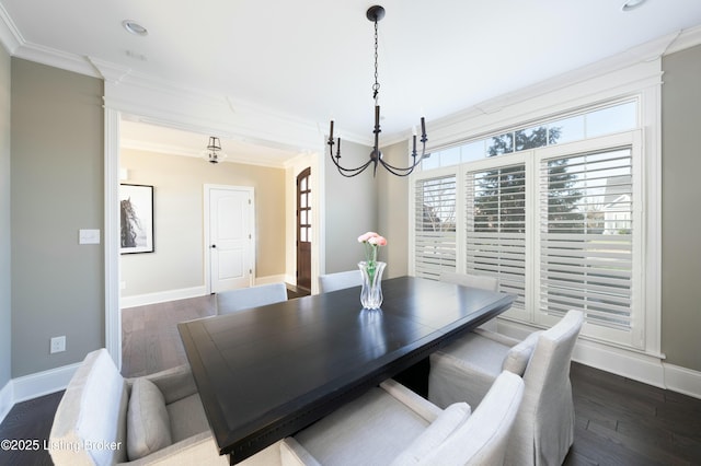 dining room with ornamental molding, dark wood-type flooring, and baseboards