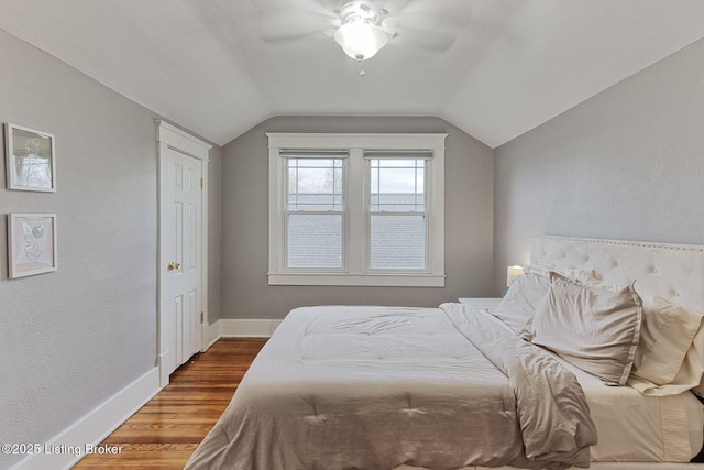 bedroom featuring vaulted ceiling, hardwood / wood-style floors, and ceiling fan