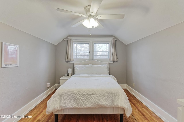 bedroom featuring lofted ceiling, hardwood / wood-style flooring, and ceiling fan