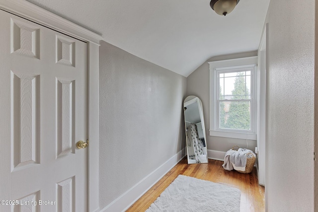 bonus room featuring light hardwood / wood-style flooring and vaulted ceiling