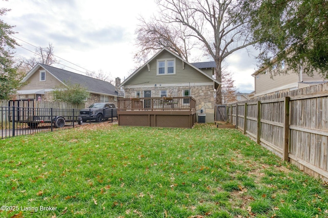 view of yard featuring a wooden deck and central AC unit