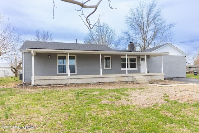5115 Flaherty Rd, Vine Grove, KY 40175 - back of property with brick siding, a porch, a chimney, and a yard