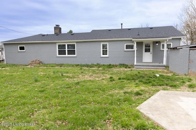 5115 Flaherty Rd, Vine Grove, KY 40175 - rear view of property with a yard, brick siding, a chimney, and a patio