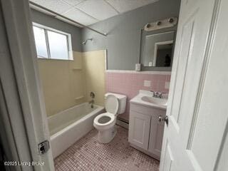 full bathroom with tile walls, tile patterned flooring, vanity, toilet, and tub / shower combination