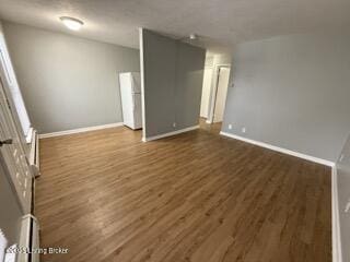 unfurnished room with dark wood-type flooring