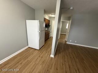 kitchen featuring white fridge and light hardwood / wood-style flooring