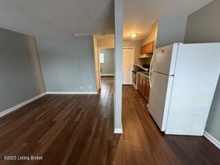 kitchen featuring white refrigerator and dark hardwood / wood-style flooring