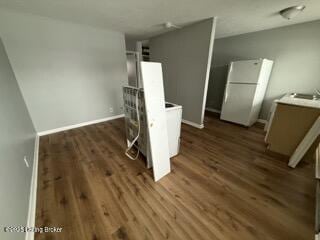 kitchen featuring dark wood-type flooring and white fridge