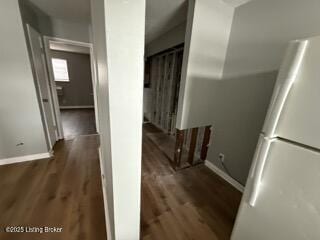 hallway with dark hardwood / wood-style floors