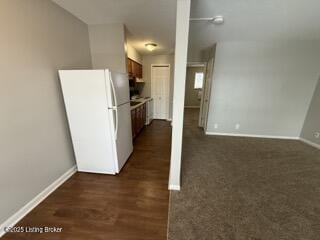 kitchen with white refrigerator and dark hardwood / wood-style flooring