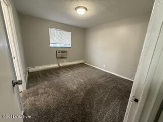 carpeted spare room with a wall unit AC