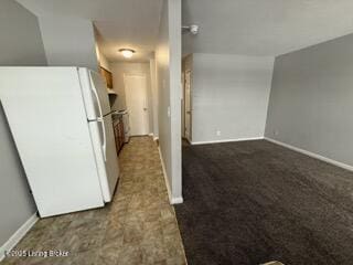 kitchen featuring dark carpet and white fridge